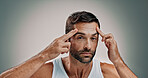 Skincare, face check and portrait in studio for man, wellness or cosmetics with space for antiaging. Male person, model and inspection for wrinkles, beauty treatment or routine on gray background