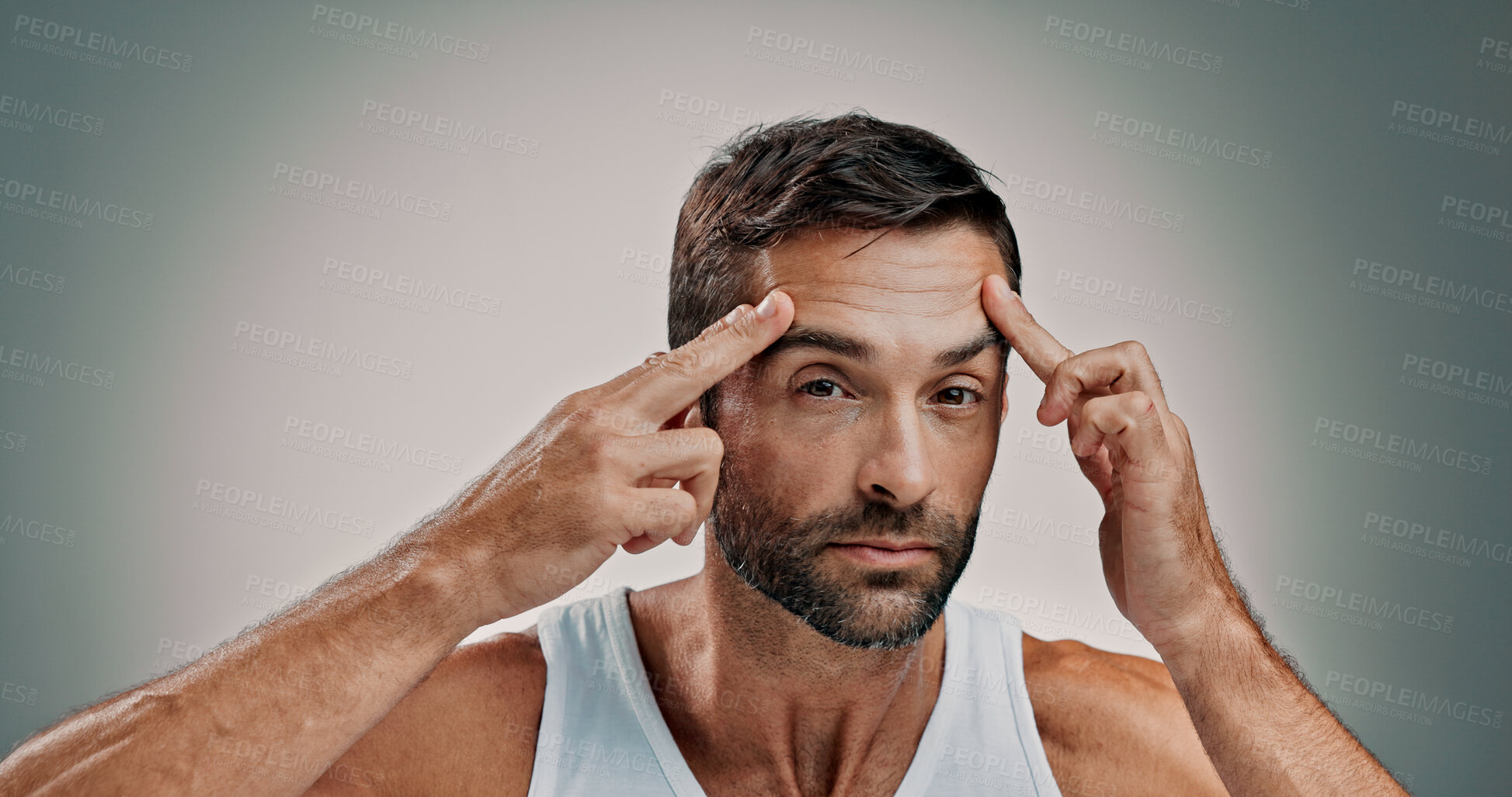 Buy stock photo Skincare, face check and portrait in studio for man, wellness or cosmetics with space for antiaging. Forehead, model and lines inspection for wrinkles, beauty treatment or routine on gray background