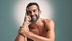 Portrait, skincare and man with confidence in studio for natural beauty, topless and muscle. Face, cosmetics and happy male model with dermatology, glow and aesthetic isolated on gray background