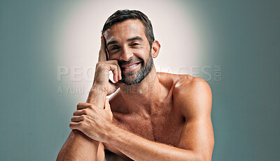 Buy stock photo Portrait, skincare and man with confidence in studio for natural beauty, topless and muscle. Face, cosmetics and happy male model with dermatology, glow and aesthetic isolated on gray background