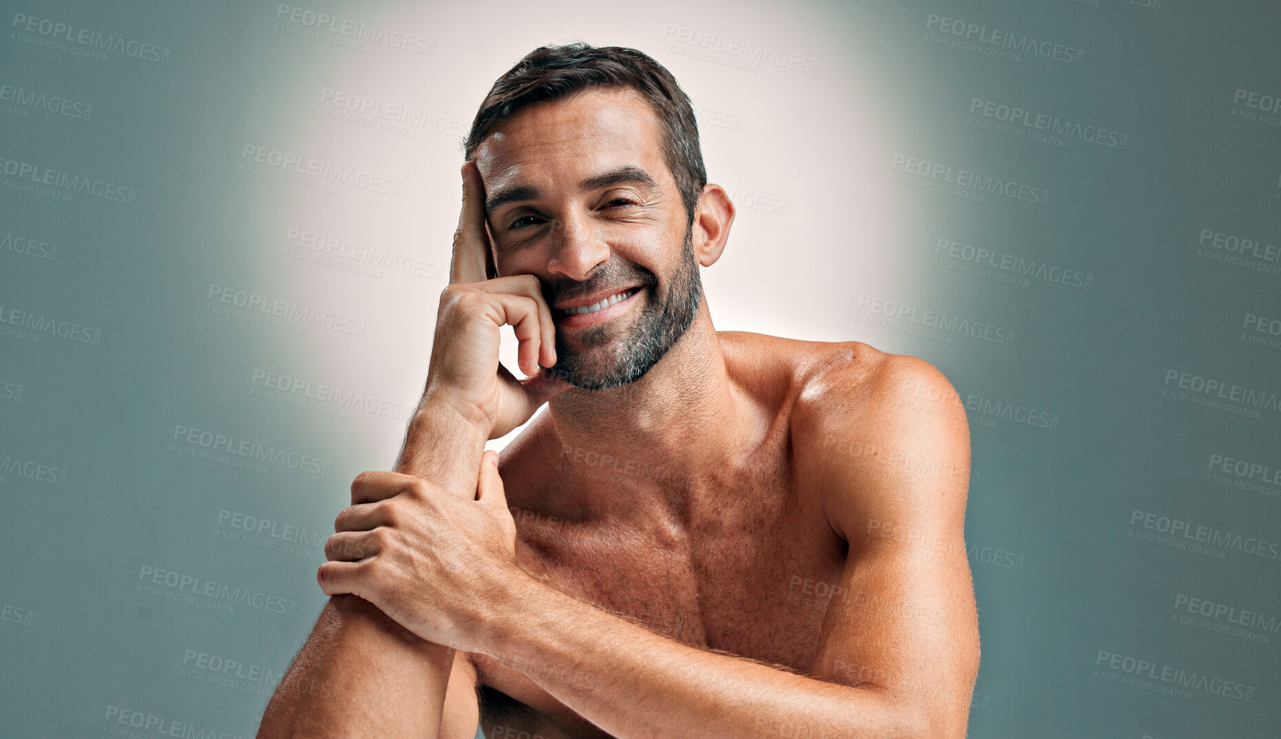 Buy stock photo Portrait, skincare and man with confidence in studio for natural beauty, topless and muscle. Face, cosmetics and happy male model with dermatology, glow and aesthetic isolated on gray background