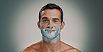 Shaving, cream and smile with portrait of man in studio for beard grooming, beauty and cleaning. Hair removal, cosmetics and self care with person on background for hygiene, skincare and salon