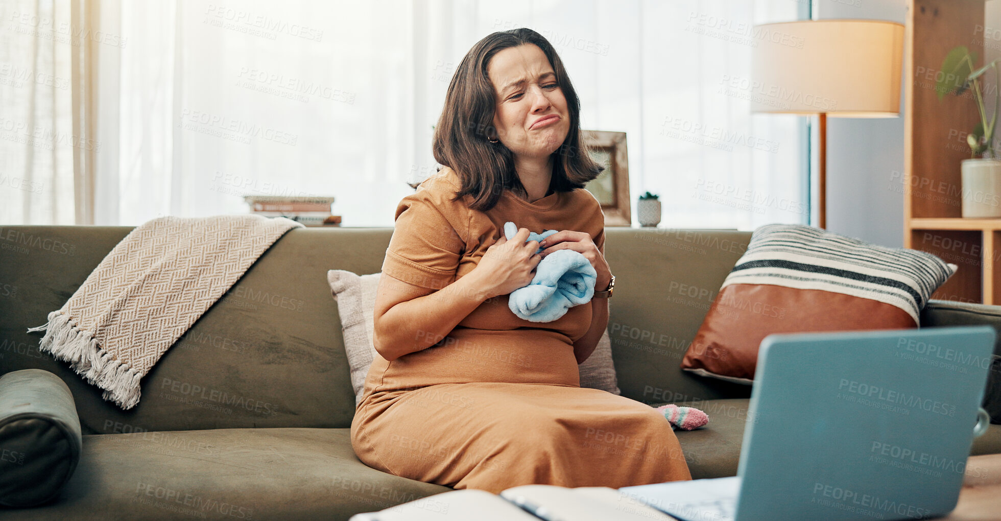 Buy stock photo Pregnant woman, video call and laptop with clothes at home for communication, gender reveal and preparation. Person, emotional and webinar for baby beanie of pregnancy news, purchase and announcement