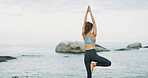Ocean, stretching and meditation for woman, outdoor and spiritual practice for wellness, peace or calm. Back, chakra and self awareness for person, mindfulness and yoga with cognitive benefits or zen