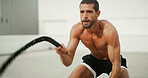 Fitness, man and battle ropes workout for core muscle, power training and endurance intensity. Athlete, person and energy with exercise equipment for agility, health performance or strength challenge