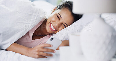 Buy stock photo Laughing, wake up or woman with phone in bed for dating website, funny joke or social media meme. Morning, happy or person with online comedy in home for status update, text message or notification