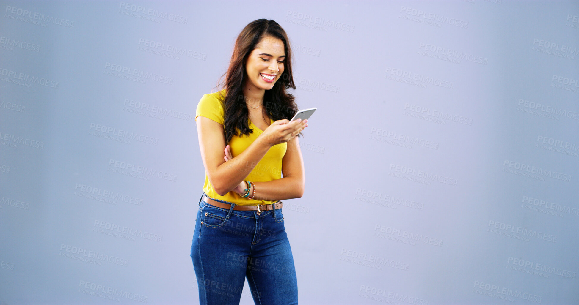 Buy stock photo Woman, phone and happy with texting in studio, chat and contact with mock up space by background. Girl, smartphone and smile with click on mobile app, notification and funny post on social network