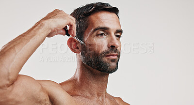 Buy stock photo Hands, man and serum for skincare in studio for beard oil, facial treatment and dermatology cosmetics. Person, product and collagen for hair growth, hyaluronic acid and anti aging on white background