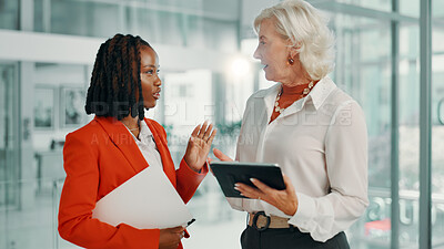Buy stock photo Meeting, proposal and tablet with business women in lobby of office for planning or strategy. Collaboration, discussion or negotiation with boss and employee in workplace for feedback or review