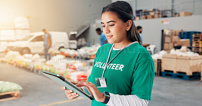 Buy stock photo Volunteer, typing and tablet with woman in warehouse for non profit, inventory checklist or donation project. Charity, social responsibility and food bank program with person in factory for ngo plan