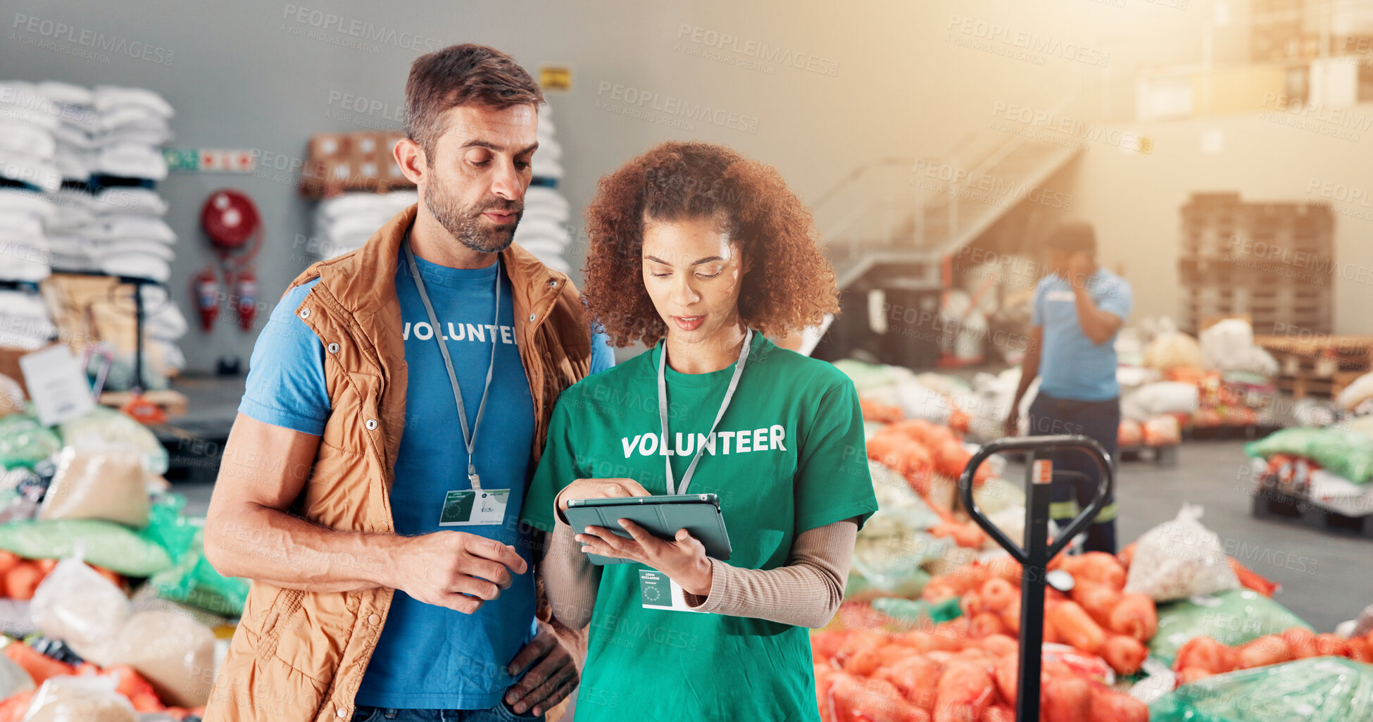 Buy stock photo Warehouse, charity and people with tablet, help and review of donations on website and discussion. Social responsibility, volunteers and group in factory with supplies for community service or NGO