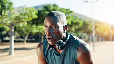 Buy stock photo Fitness, tired and black man with breathing outdoor for exercise fatigue, running burnout and break. Athlete, runner and exhausted with headphones for workout podcast, rest or cardio recovery at park