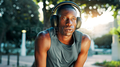 Buy stock photo Fitness, tired and black man with headphones in nature for workout podcast, running challenge and breathing break. Athlete, runner or relax at park with exercise playlist, sweat and marathon recovery
