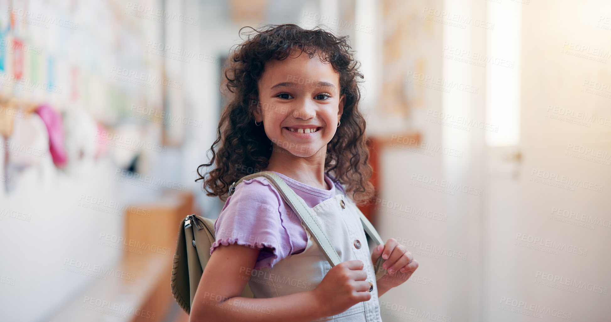 Buy stock photo Happy, backpack and portrait of child in school for learning, development or growth on campus. Pride, kid and face of girl student in hallway for education, studying or lesson at kindergarten academy