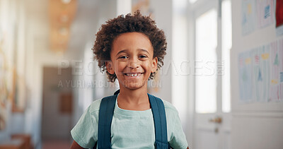 Buy stock photo Smile, backpack and portrait of child in school for learning, development or growth on campus. Pride, kid and face of boy student in hallway for education, studying or lesson at kindergarten academy