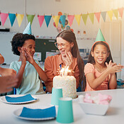 Birthday, cake and kids with teacher in classroom for group party with ...