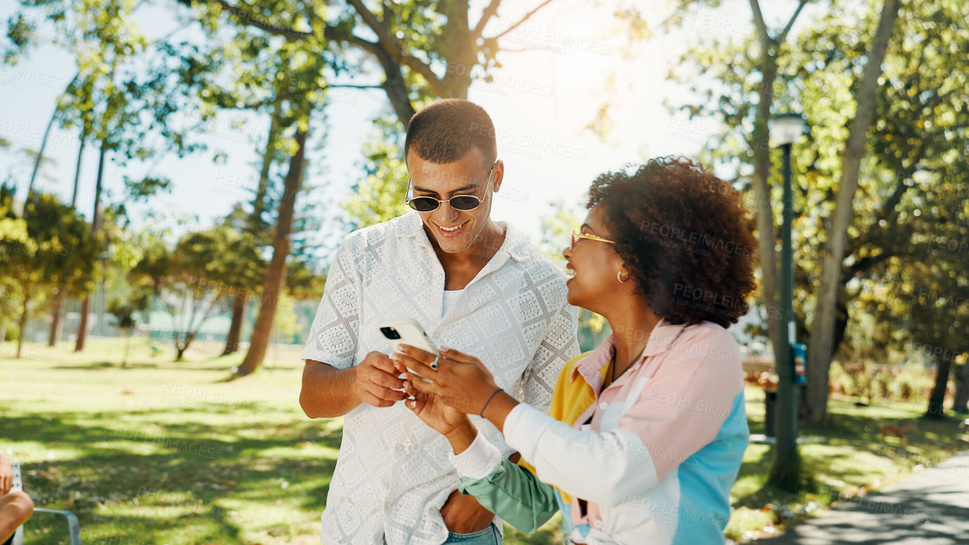 Buy stock photo Couple of friends, mobile and happy outdoor for social media post, online blog and reading text message. Phone, gen z man and woman at park together for internet, communication and show video on app