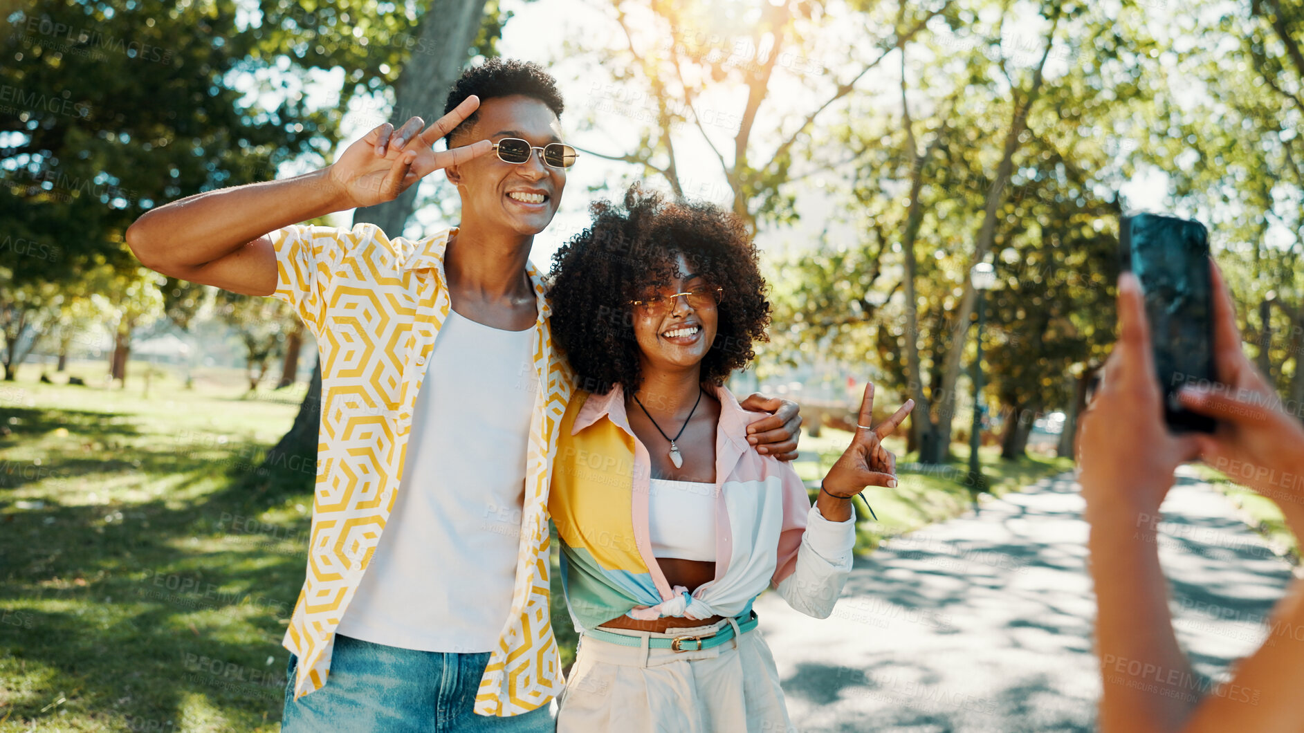 Buy stock photo Fashion, happy or couple in park for photograph together for love, bonding or relationship in summer. Peace sign, social media influencers or man with women in nature for picture, vacation or holiday