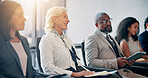 Business, listening and audience in conference, happy and colleagues in workshop for training or meeting. Seminar, information and coworkers with notes for presentation, crowd and people in boardroom