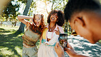 Holiday, happy people and friends in park for picture together for fashion, bonding or reunion. Gen z, social media influencer or man with women in outdoor nature for photograph, vacation or hangout
