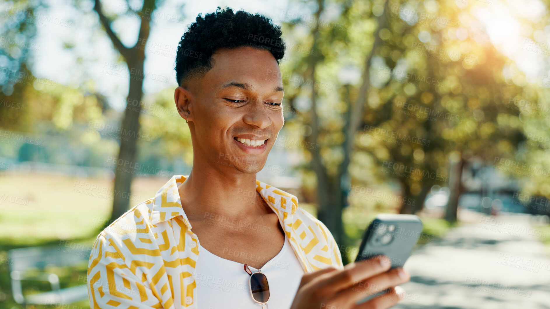 Buy stock photo Smile, man and student with phone at park for communication, social media and reading blog. Happy, person and mobile on study break, university results and application feedback with scholarship guide