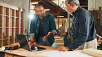 Talking, carpenter or people on laptop in warehouse for factory, check inventory or furniture production. Woodworking, carpentry and online update for timber supply, lumber and construction business 