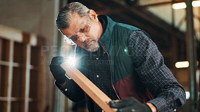 Buy stock photo Carpenter, mature and sanding wood for construction, furniture or renovation project planning. Woodworker, person and plank with tools in creative carpentry workshop for manufacturing, art and craft