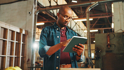 Buy stock photo Man, engineer and carpenter with tablet in workshop for manufacturing and furniture production. African person, carpentry and technology in factory for construction, building or check woodwork design