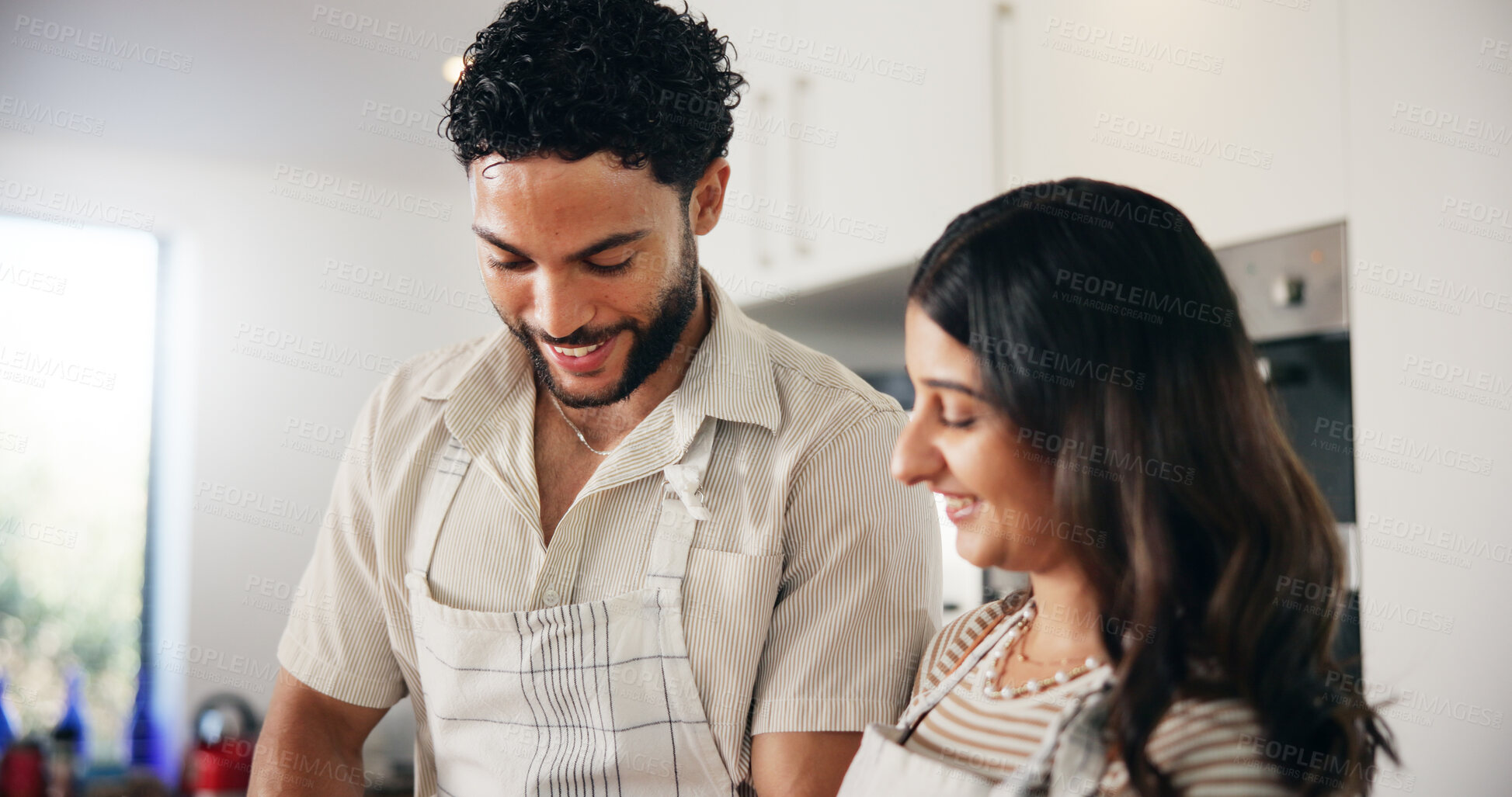 Buy stock photo Home, cooking and couple in kitchen, love and bonding together with apron, romance and relationship. People, apartment and man with woman, happiness and healthy meal with smile, lunch and marriage