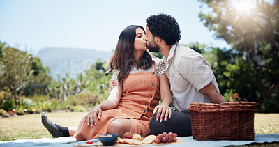 Buy stock photo Date, kissing and picnic with couple in park together for bonding, eating food or relationship. Anniversary, love or romantic with man and woman outdoor in nature for valentines day celebration