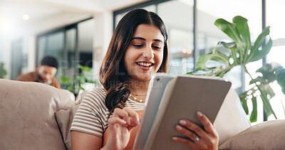 Buy stock photo Woman, relax and reading on sofa with tablet, social media and ebook for weekend chill in home. Person, happy or tech in living room for streaming subscription, email notification or download new app