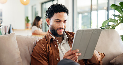 Buy stock photo Man, relax and smile on sofa with tablet, social media and research for new home improvement. Person, network or tech in living room for planning renovation, reading or online creative platform