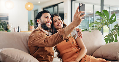 Buy stock photo Selfie, smile and couple in home, relax and post for memory in social media, bonding and chilling. Embrace, man and woman with picture, photography and break in living room with spouse, love or house