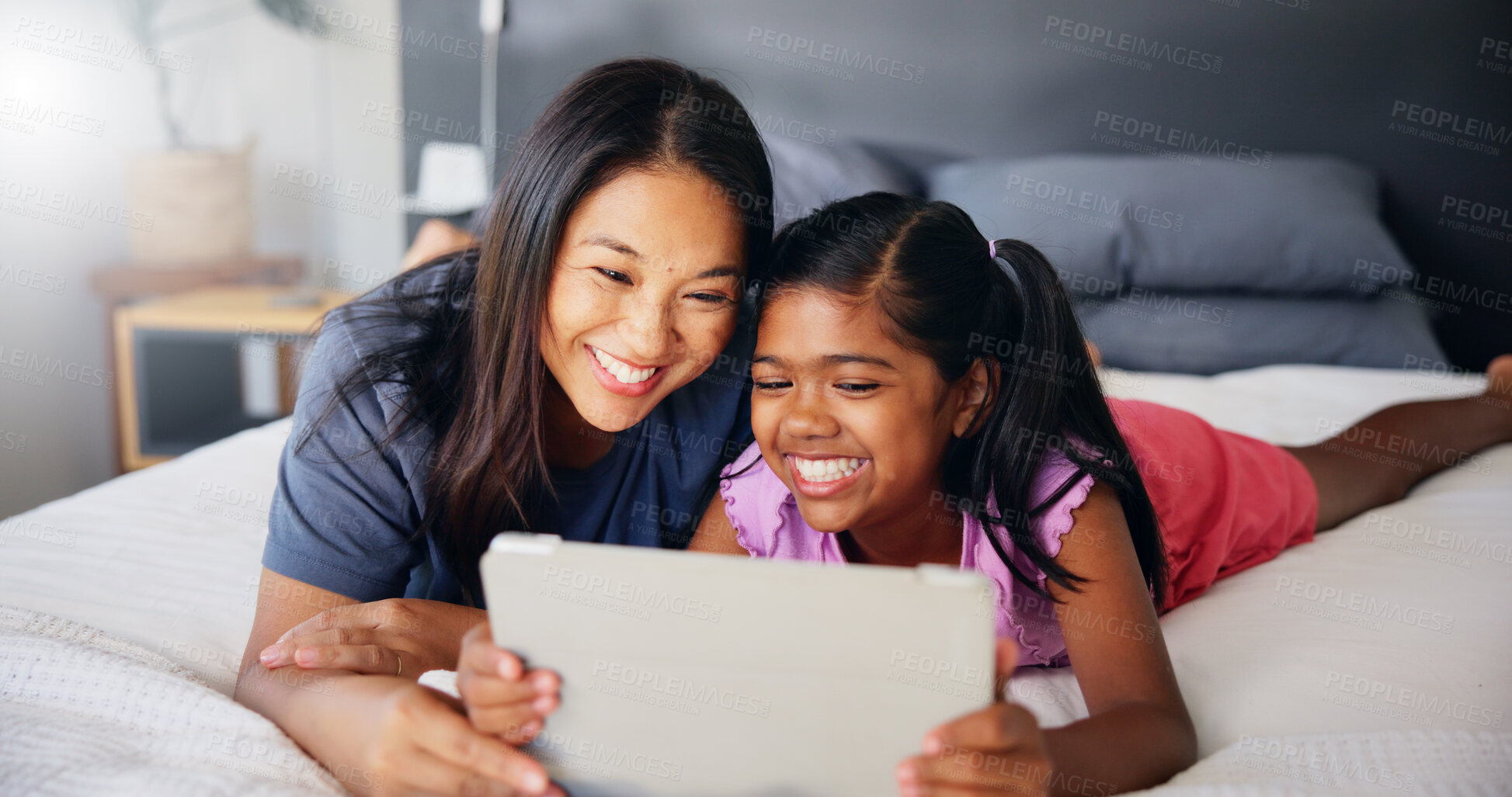 Buy stock photo Smile, tablet and mother with daughter in bedroom for streaming service, movie subscription and comedy. Happy, cartoon and entertainment with woman and child at home for app, digital and bonding 