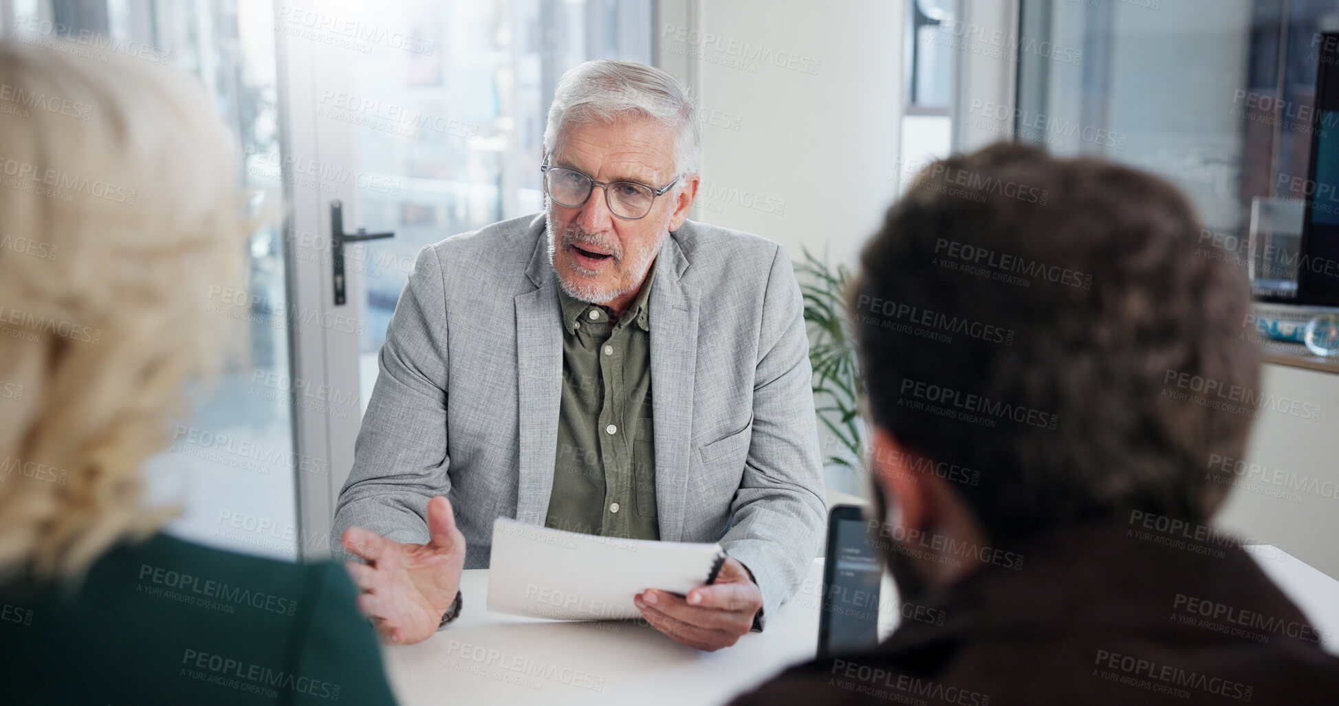 Buy stock photo Office, meeting and businessman with document for discussion, investment briefing or review finance. Collaboration, employees or mature financial advisor with paperwork for feedback, report or laptop