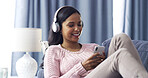 Woman, relax and headphones with phone at house for streaming, listening to music and chat. Smile, person and mobile internet for podcast audio, sound app and download radio of weekend entertainment 