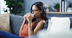 Woman, relax and drink coffee at house with peace, calm morning and weekend break with past memory. Female person, thinking and beverage with comfort, reflection and nostalgia for self care in lounge