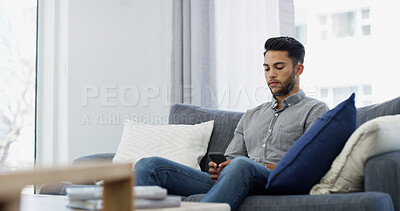 Buy stock photo Man, relax or typing with phone on sofa for online communication, texting or chatting at home. Male person, user or browsing with mobile smartphone for connection, network or app on living room couch
