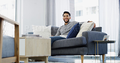 Buy stock photo Happy man, relax and weekend with sofa for morning, comfort or peace in living room at home. Male person, holiday or sitting with cheerful smile in joy on couch for calm day, break or rest at house