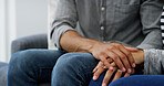 Couple, holding hands and touch with empathy on sofa for love, care or commitment at home. Closeup, man and woman with sympathy for bonding, cherish or romance together on living room couch at house