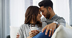 Forehead touch, sofa and couple with coffee for romance, bonding and relax together. Home, dating and happy man and woman with drink for relationship, affection and embrace for love in living room