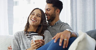 Buy stock photo Happy, relax and couple with coffee in home for conversation, bonding and chill together. Living room, dating and man hug woman with drink on sofa for relationship, affection and embrace for love