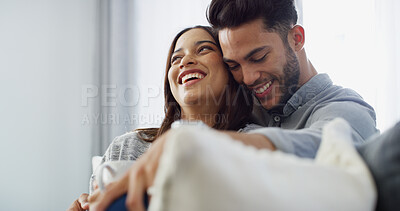 Buy stock photo Hug, laughing and couple with coffee, house and love in living room with woman, comfortable and bonding. Happy, man and relax with partner in lounge, tea and chilling in home, embrace or relationship