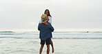 Couple, lifting and beach for fun on vacation with honeymoon, holiday or bonding outdoor in nature. Excited woman, man and joy by sea for memory, playful date and happy with space and energy
