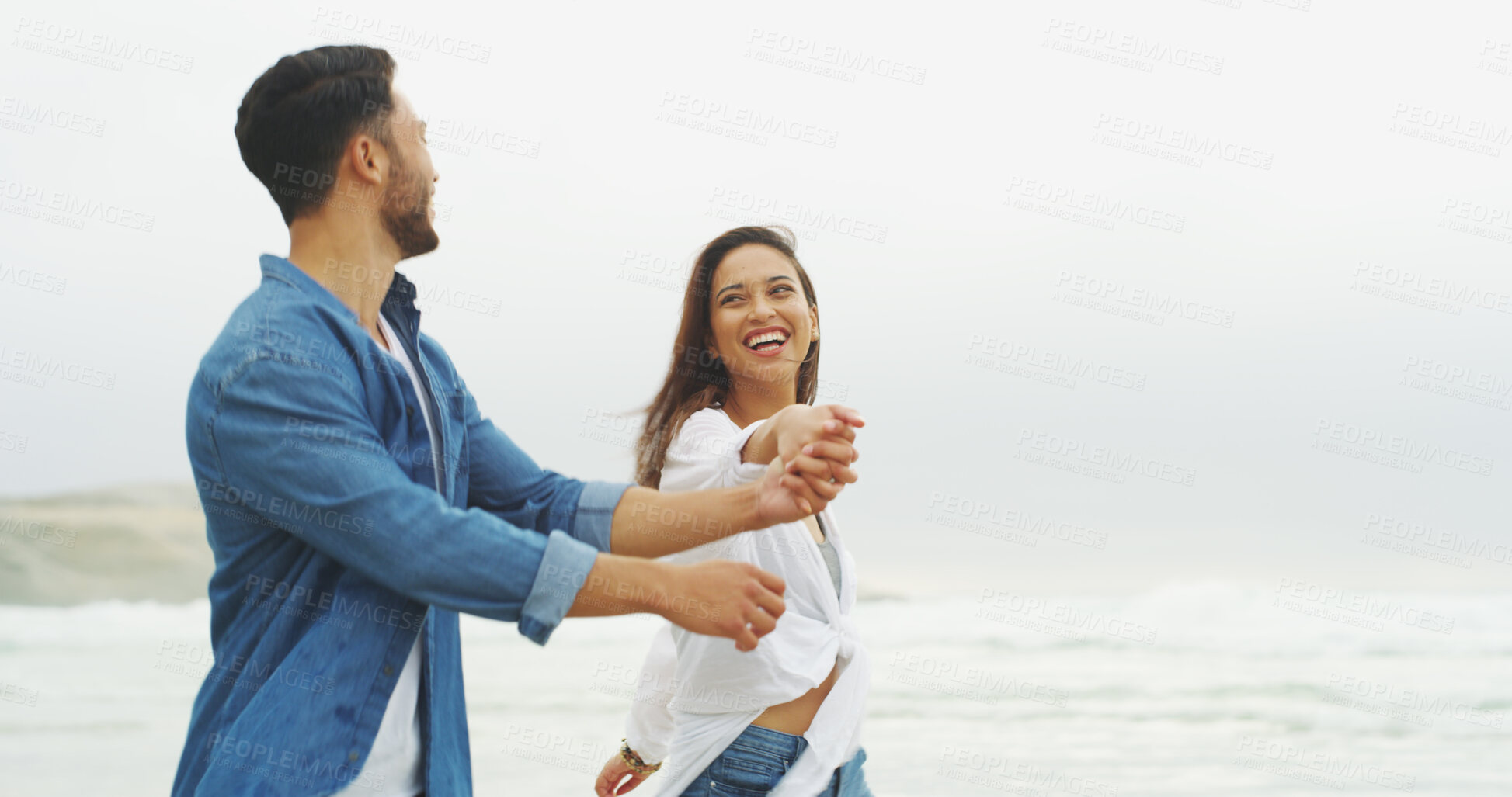Buy stock photo Happy couple, beach and holding hands with love on vacation for honeymoon, holiday or bonding outdoor. Woman, man and relationship by sea for laugh, romantic date and space with playful partner