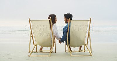Buy stock photo Beach chair, couple and holding hands on vacation for honeymoon, holiday or bonding outdoor. Woman, man and relationship by sea for space, romantic date and care with security in commitment 