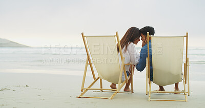 Buy stock photo Beach chair, couple and relax on vacation for honeymoon, holiday or bonding outdoor. Woman, man and relationship by sea for space, romantic date and care with forehead touch for connection in nature