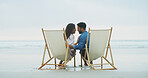 Laugh, beach chair and couple with love on vacation for honeymoon, holiday or bonding outdoor. Woman, man and relationship by sea for romantic date, funny joke and care with connection by space