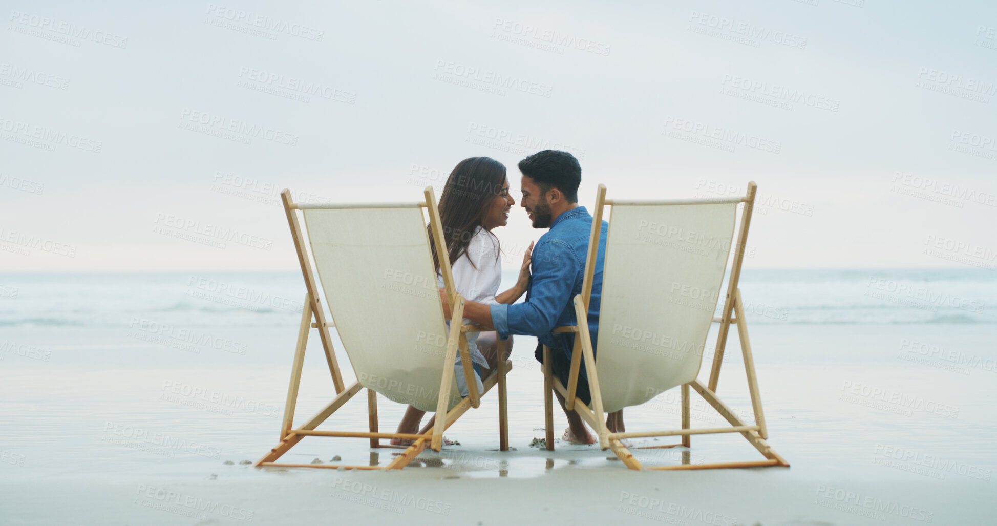 Buy stock photo Laugh, beach chair and couple with love on vacation for honeymoon, holiday or bonding outdoor. Woman, man and relationship by sea for romantic date, funny joke and care with connection by space