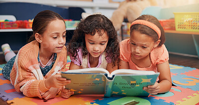 Buy stock photo Girls, reading book and group on carpet, school and learning with education, children and bonding together. Friends, storytelling and kids in classroom, literacy knowledge and happiness with fantasy